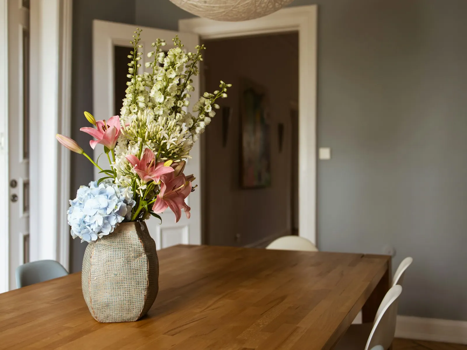 A solid timber dining table shown as a representative custom-furniture direction