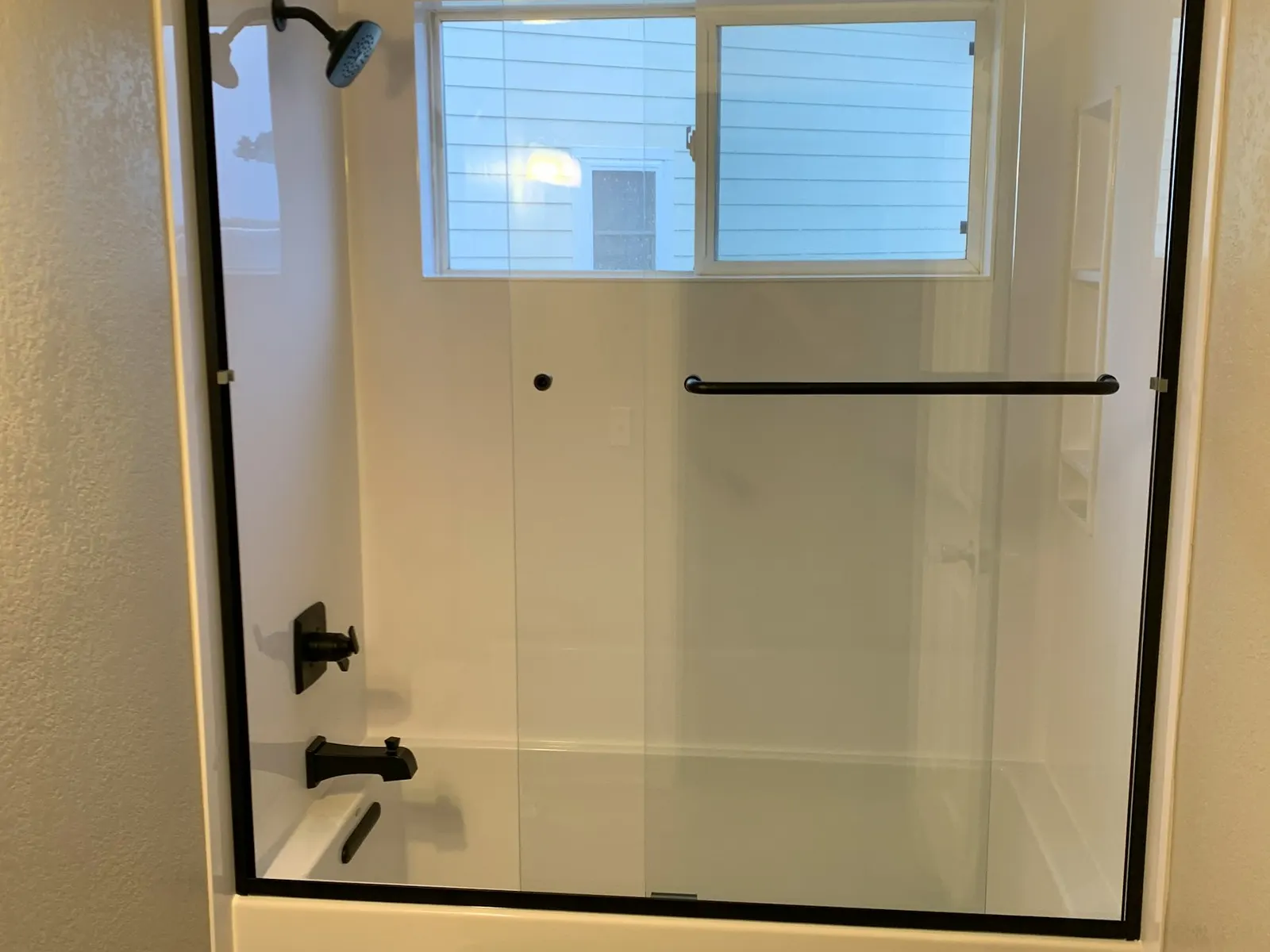 A clear glass shower enclosure shown as a representative bath direction